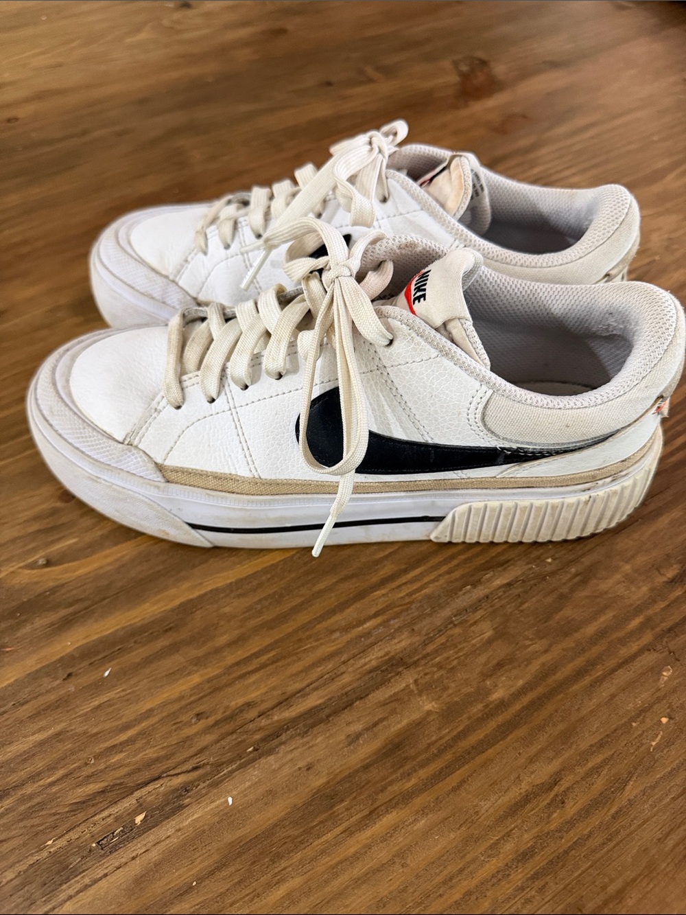Nike White Sneakers with Black Swoosh and Cream Trim